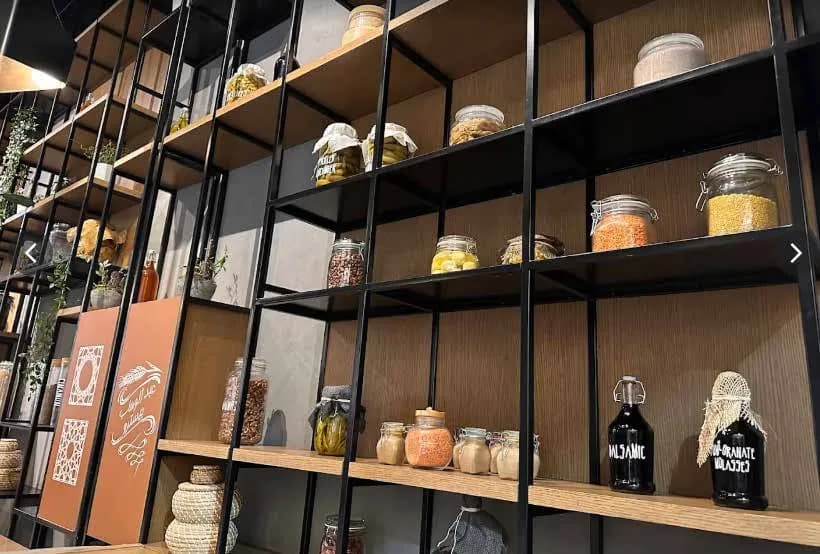 Abdelwahab open shelving display with steel framing and ceramics