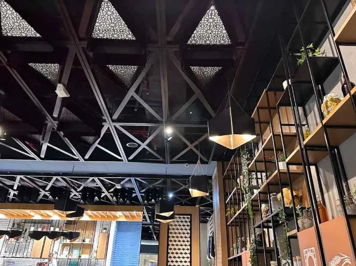 Abdelwahab interior with exposed ceiling and geometric lighting