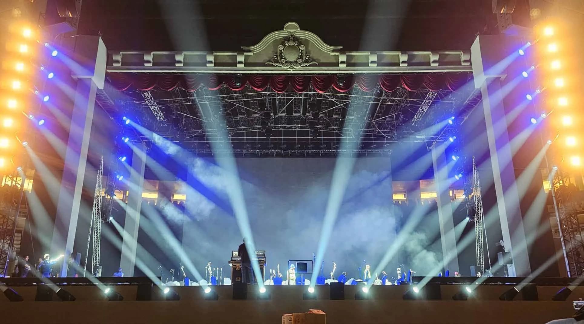 Andrea Bocelli stage under full lighting and haze during the performance