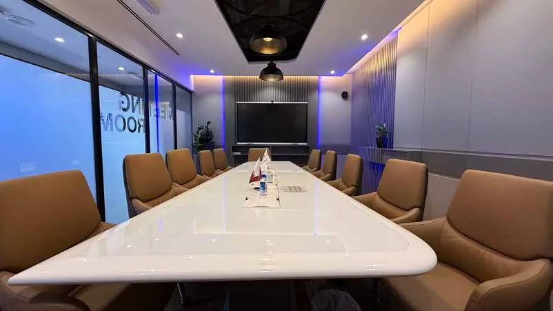 Bayanat Engineering boardroom with a sculpted table and acoustic ceiling