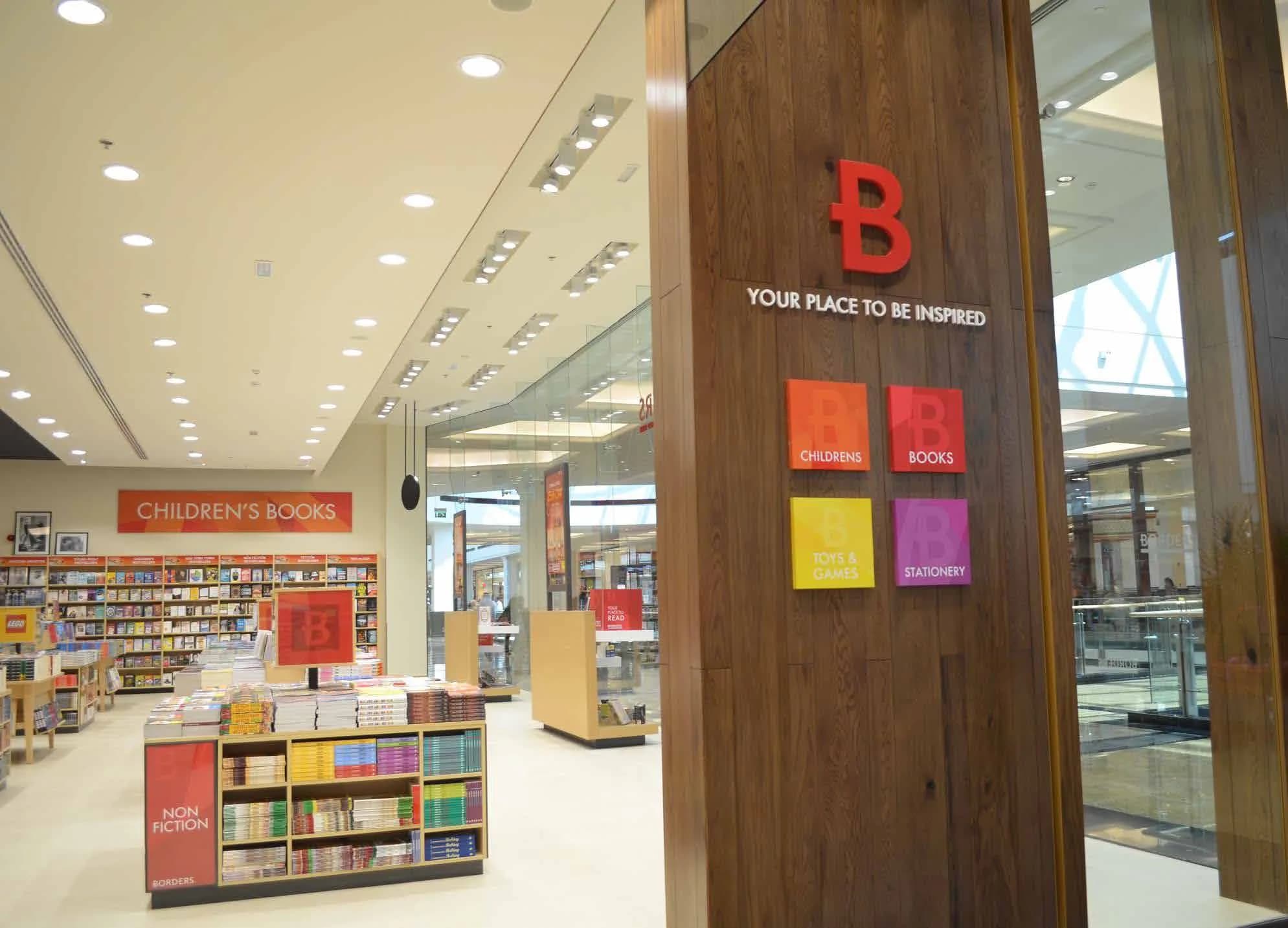 Borders sales floor with timber portal and colour-coded wayfinding