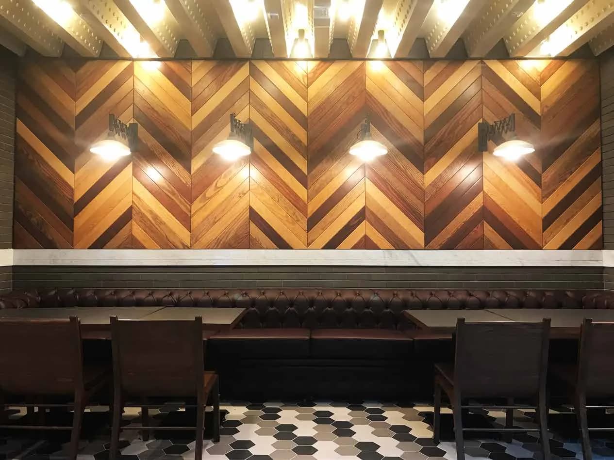 Casper & Gambini's chevron timber wall with warm accent lighting