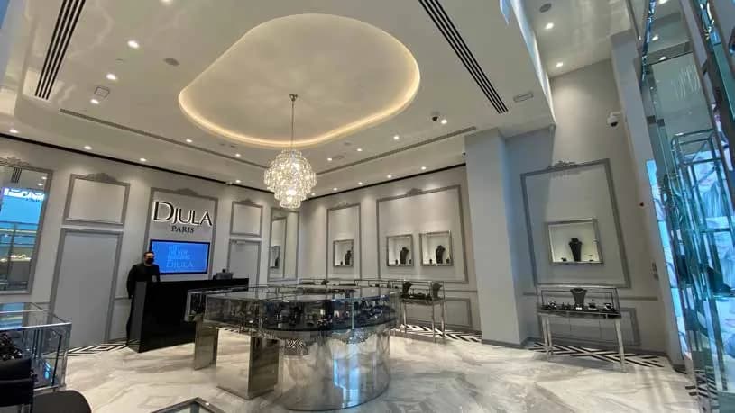Djula boutique with cove-lit ceiling and stainless steel counter