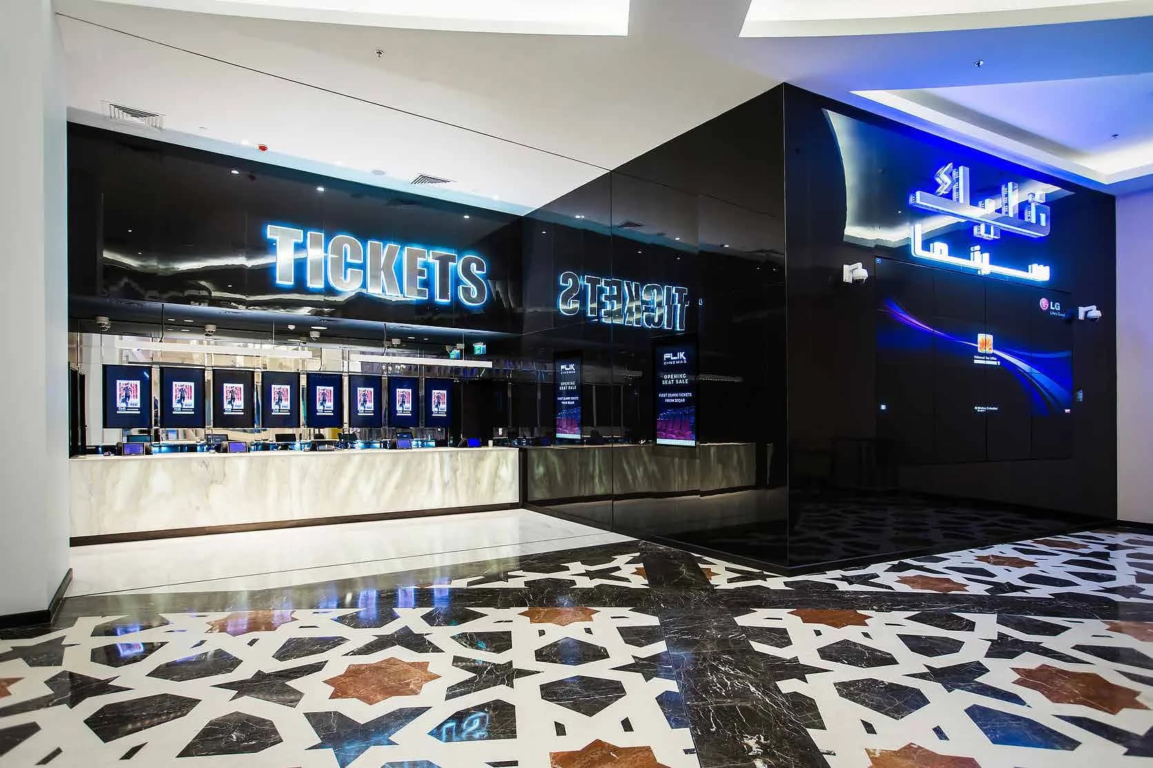 Flik Cinemas ticketing hall with backlit counters and digital signage