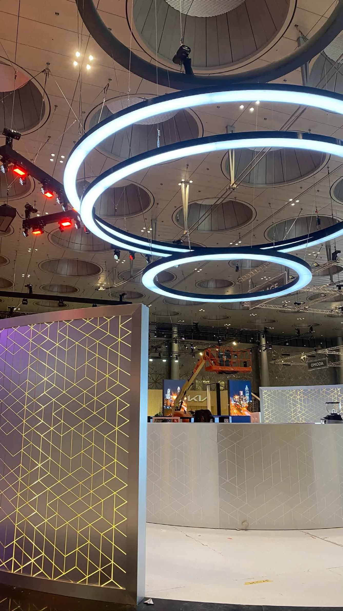 Backlit mashrabiya aluminium screen and ring chandeliers at GIMS