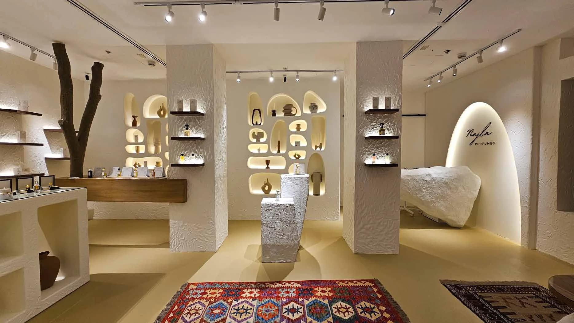 Najla Perfumes plinths and shelving with layered lighting