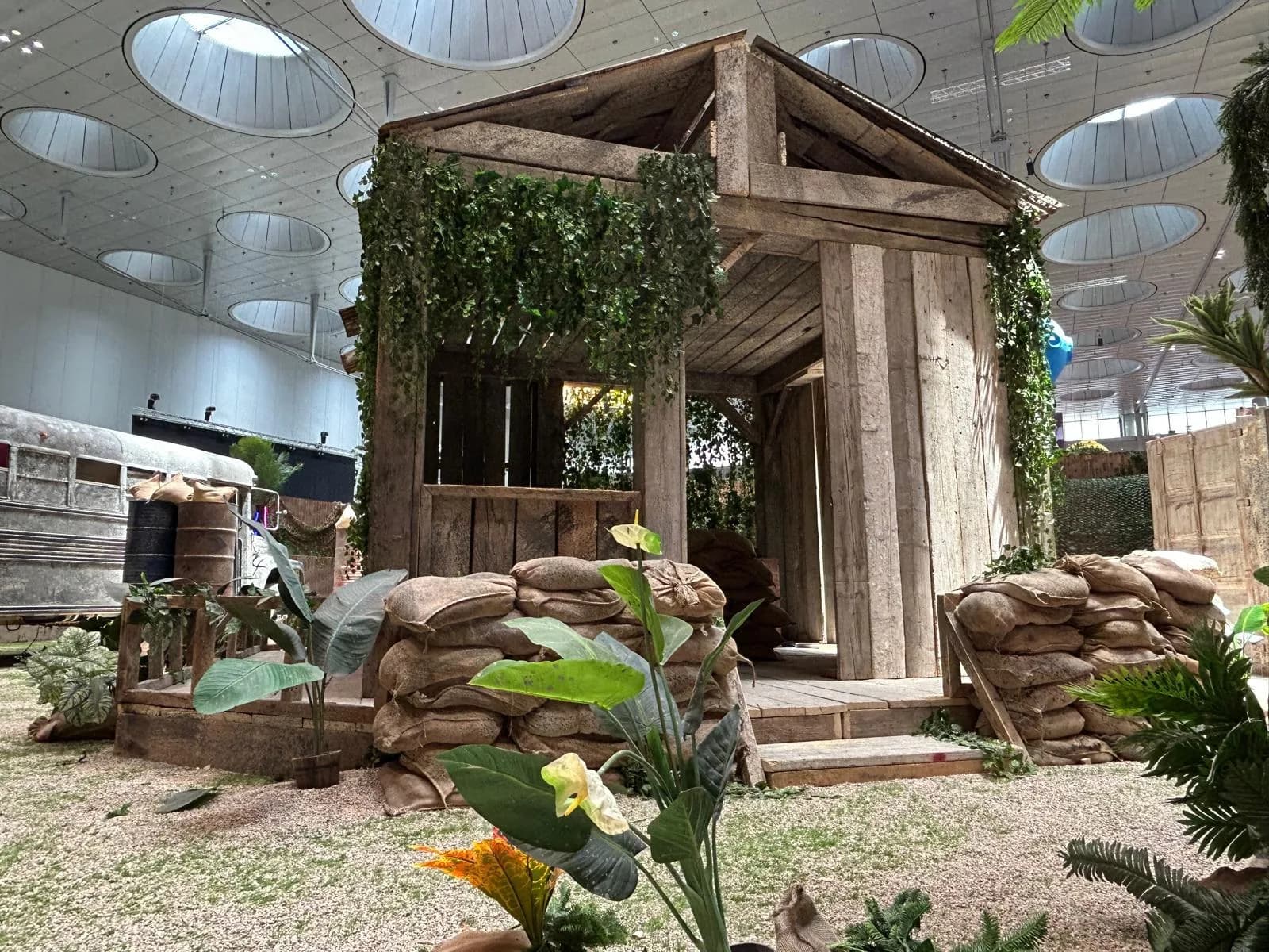PUBG Mobile activation with timber cabin, barrels and foliage