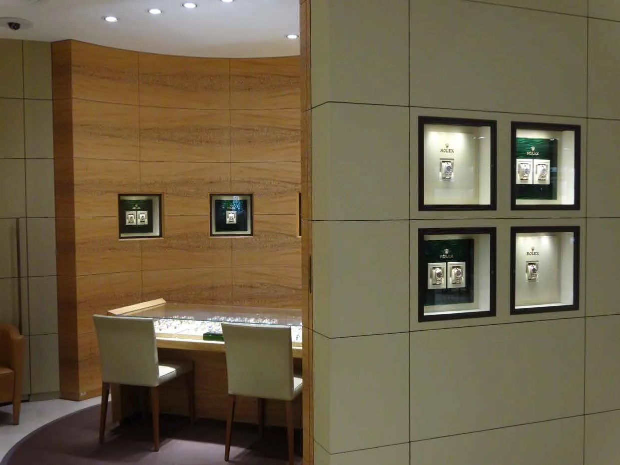 Rolex boutique interior with framed displays and seated consultation area