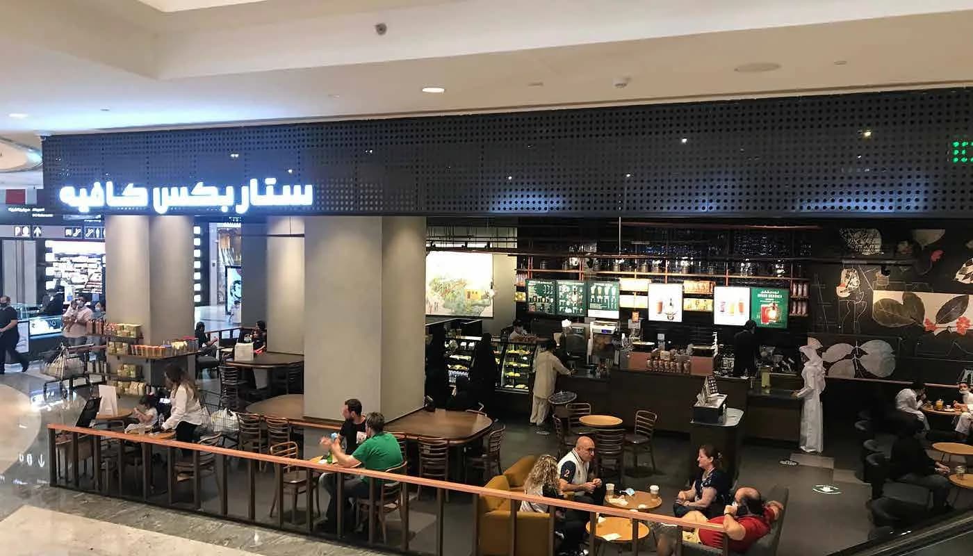 Starbucks facade and seating area within the mall concourse