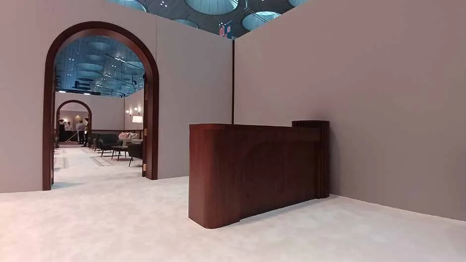 Arched solid timber doorway and reception counter at the HH Majlis