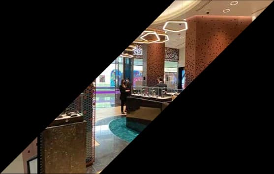 Jewellery boutique interior with perforated bronze walls and display islands
